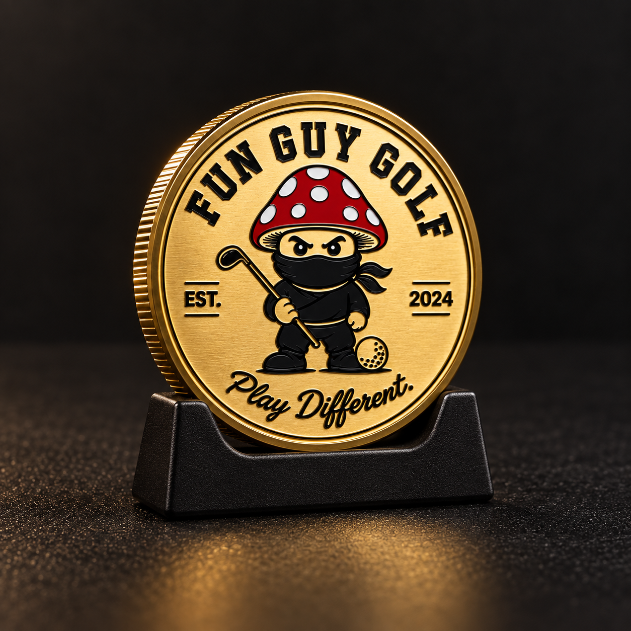 Gold Fun Guy Golf ball marker on its display stand against a dark background