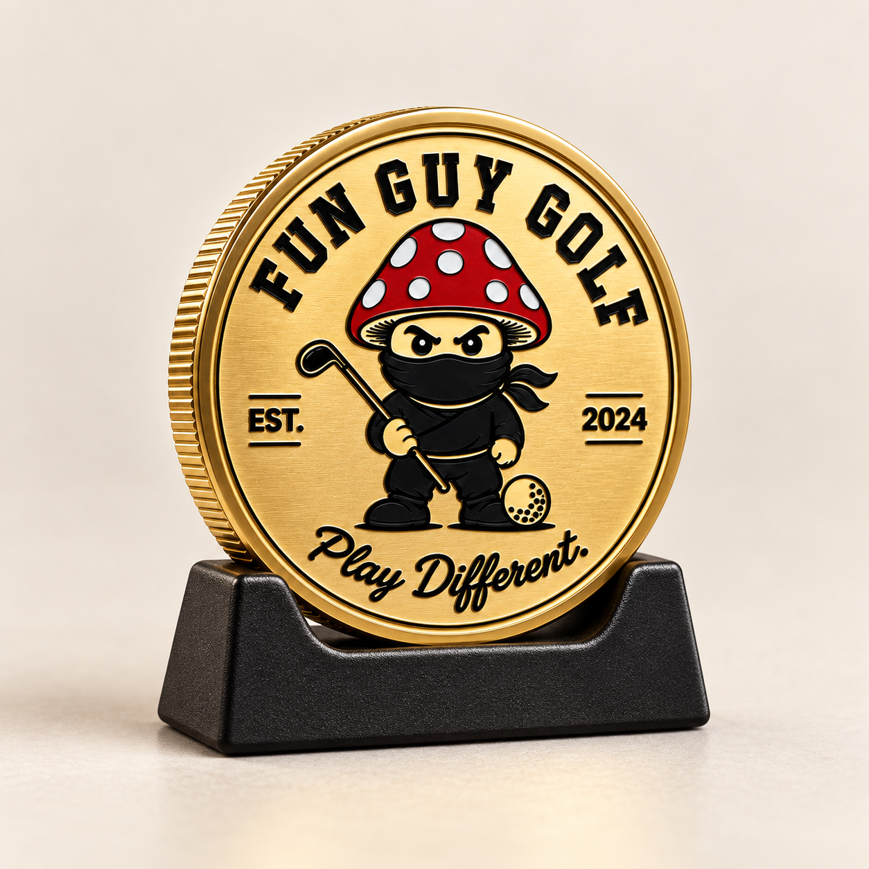 Gold Fun Guy Golf ball marker on a black stand against a white background